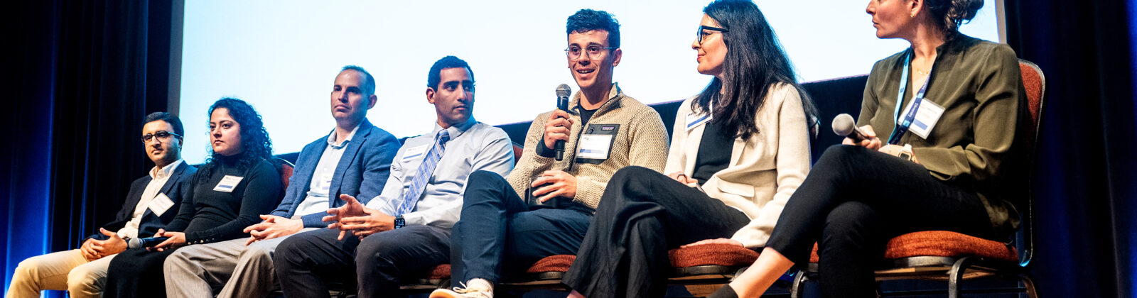 Panelists discuss AI in the Health System during Research AI Day at UCSF’s Mission Bay campus on Monday, March 17, 2025. From right to left are Julia Adler Milstein, Jinoos Yazdany, Adam Yala, Andrew Bishara, Lucas Zier, Priya Ramaswamy and Hossein Solemani. (Photo by Noah Berger)
